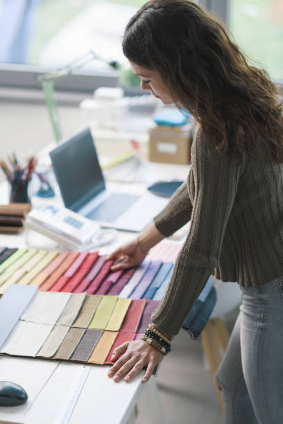 istock Professional decorator choosing fabric swatches 1352194779