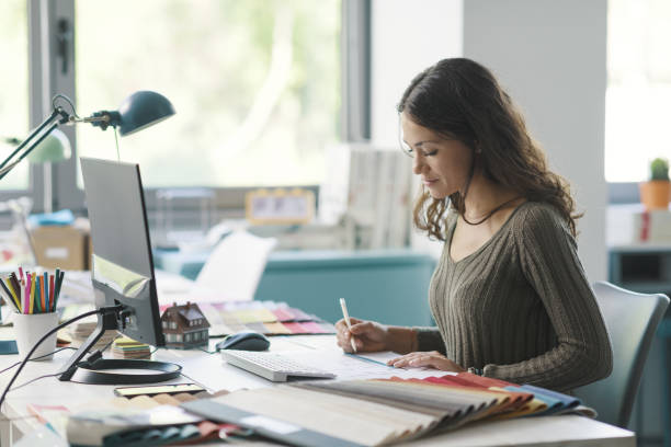 istock Professional interior designer sitting at desk and working 1352194849