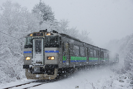 Niki-cho, Hokkaido, Japan - November 19, 2017 : KIHA 201 Rapid train “Niseko liner” running in the snowfall