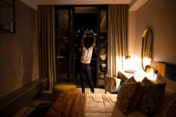 African female standing stretching in room taking a break from work