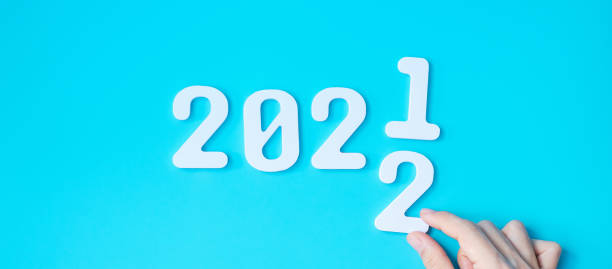 istock hand change 2021 to 2022 number on blue background. Plan, finance, Resolution, strategy, solution, goal, business and New Year holiday concepts 1352197301