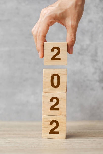 istock hand holding block 2022 text on table. Resolution, strategy, plan, goal, motivation, reboot, business and New Year holiday concepts 1352197365