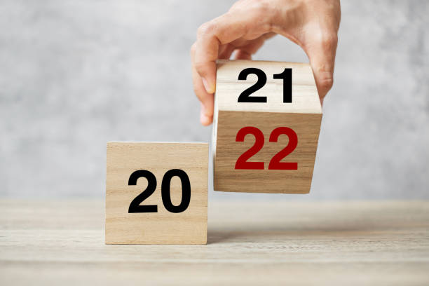 istock hand flipping block 2021 to 2022 text on table. Resolution, strategy, plan, goal, motivation, reboot, business and New Year holiday concepts 1352197740