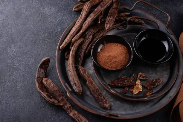 Photo of Carob pods, powder and molasses or syrup