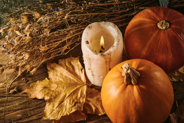 istock Autumn pumpkins and a candle on a wooden background 1352201848