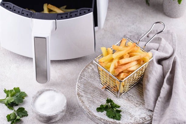 French fries cooked in air fryer. French fries cooked in air fryer. Healthy fat less food deep fryer stock pictures, royalty-free photos & images