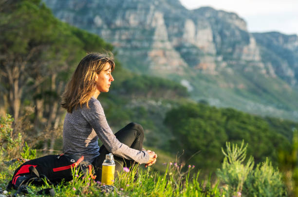 istock Fit woman taking a break from a mountain hike at a scenic viewpoint 1352202295