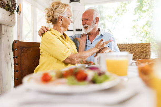 istock Happy senior couple talking during a meal in dining room. 1352202324