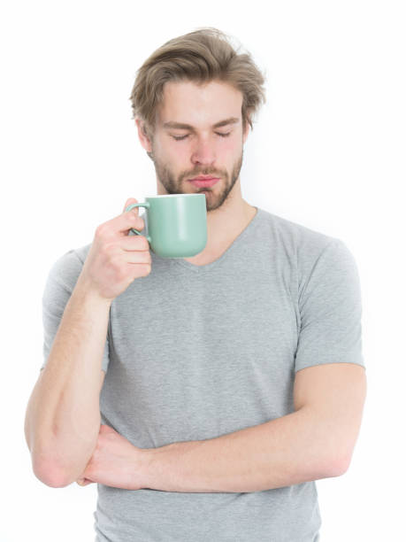 istock sleepy man with tea or coffee cop in morning 1352204959