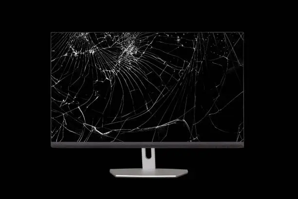 computer monitor with a broken screen isolated on a black background