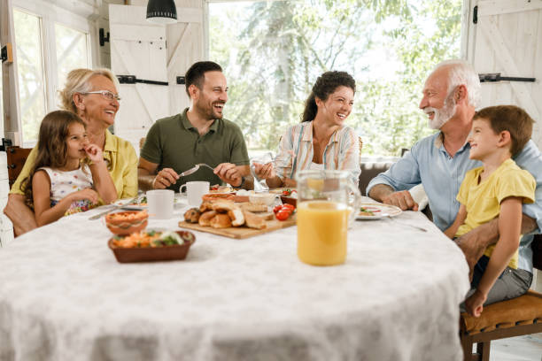 istock Happy extended family having a meal at dining table. 1352207925