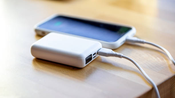 istock A smartphone is charged from a small white power bank. 1352208848