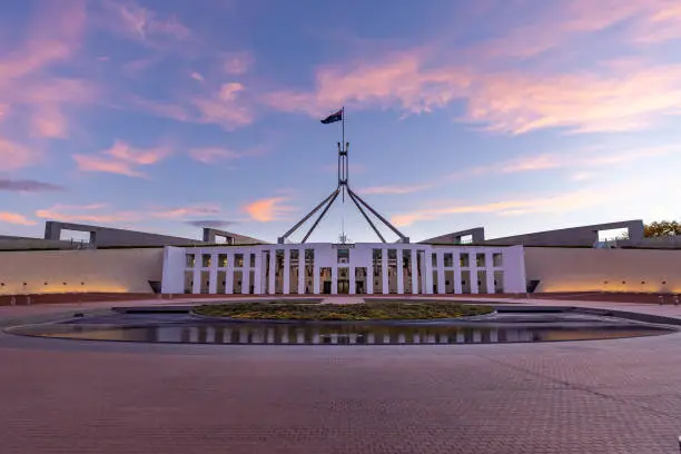 a sunset wide view of federal parliament house at canberra in the act, australia