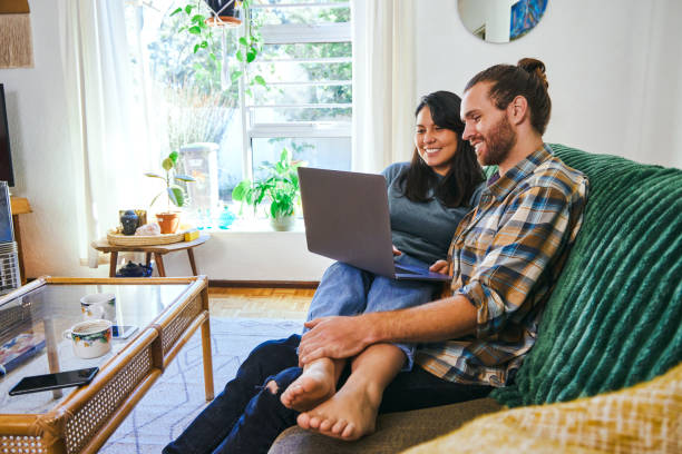 istock Shot of a young couple relaxing together while using their laptop 1352214603