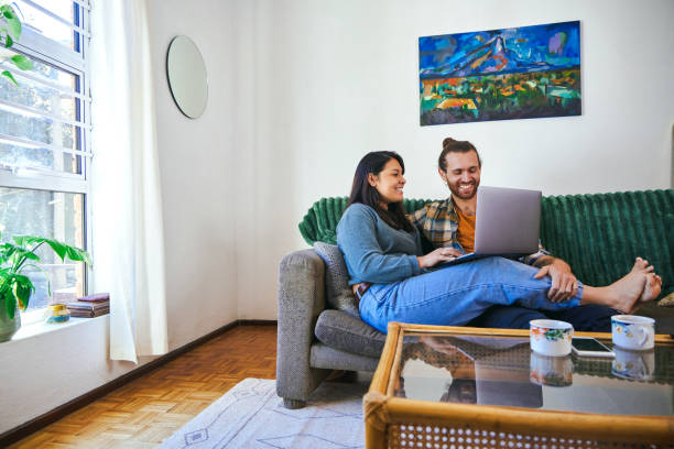 istock Shot of a young couple relaxing together while using their laptop 1352214604