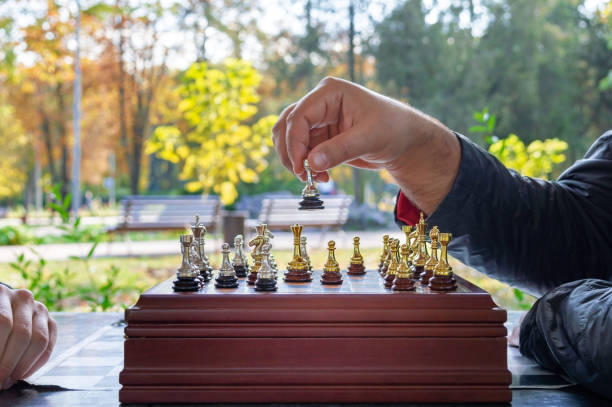 istock Playing chess outdoors in the autumn park. 1352215196
