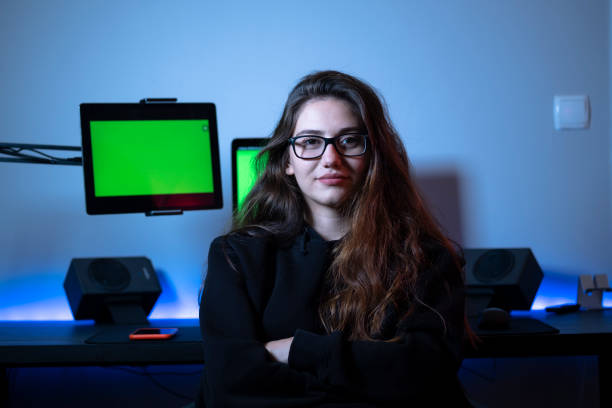 istock Young beautiful girl sitting in front of computer desk and tablet computer behind her 1352215550