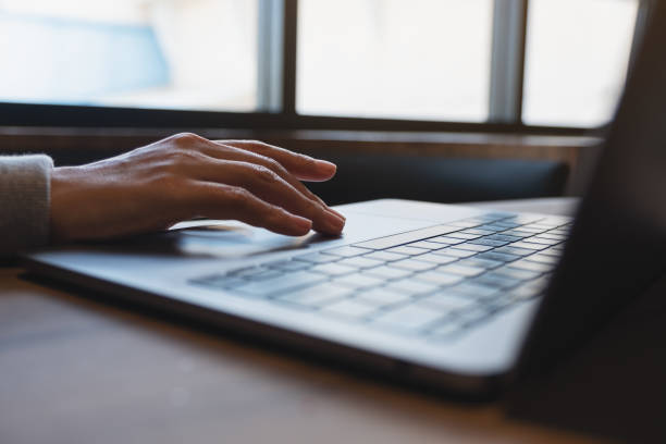 istock A woman working and touching on laptop computer touchpad on the table 1352218071