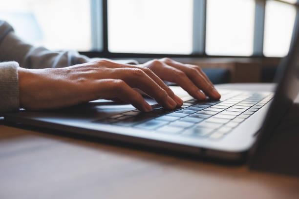 istock A woman working and typing on laptop computer keyboard on the table 1352218604