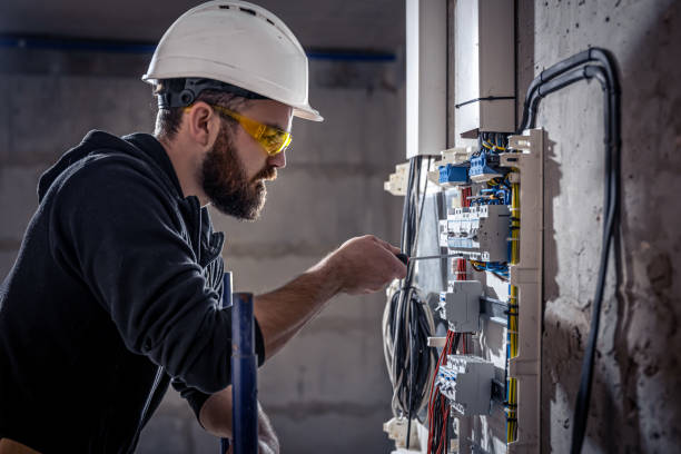 istock A male electrician works in a switchboard with an electrical connecting cable. 1352218984
