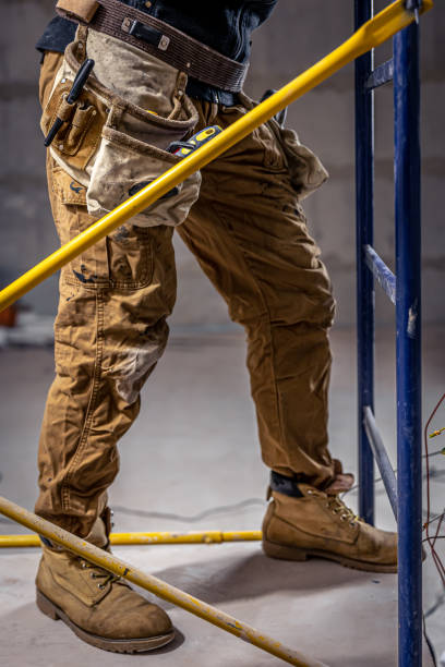 istock A male electrician works in a switchboard with an electrical connecting cable. 1352218992