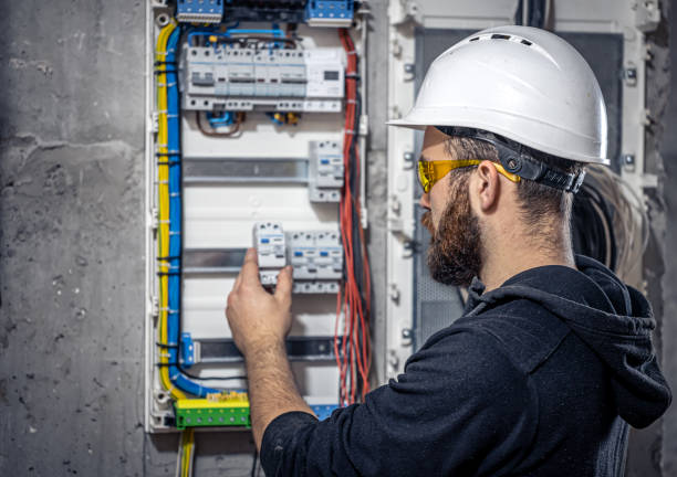 istock A male electrician works in a switchboard with an electrical connecting cable. 1352219001