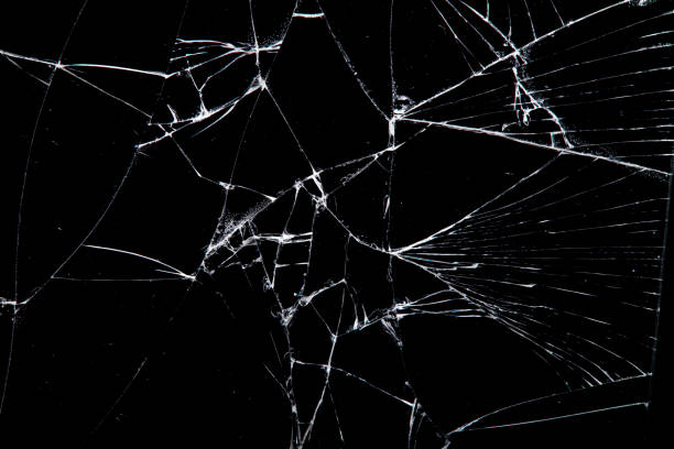 istock cracked glass isolated on a black background. 1352219113