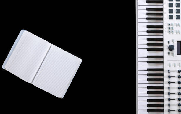 istock Music keys and notepad on black background, top view, flat lay. 1352220978