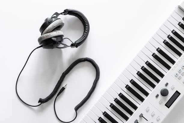 istock Musical flat lay background with headphones musical keys. 1352221234