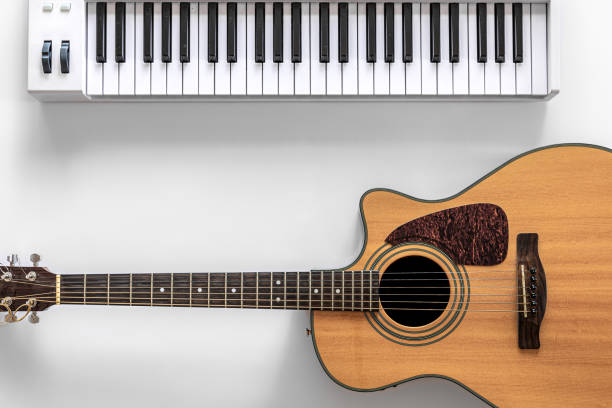 istock Acoustic guitar and musical keys on a white background, flat lay. 1352221511