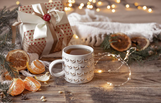 istock Christmas composition with a festive cup and tangerines on a blurred background. 1352221818