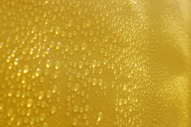 istock Fresh water drops and yellow background 1352222138