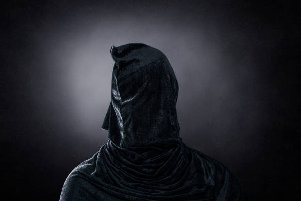 istock Creepy figure over dark misty background 1352222349