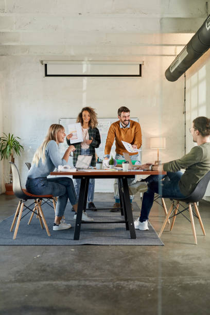 Young happy creative team having a meeting at casual office.