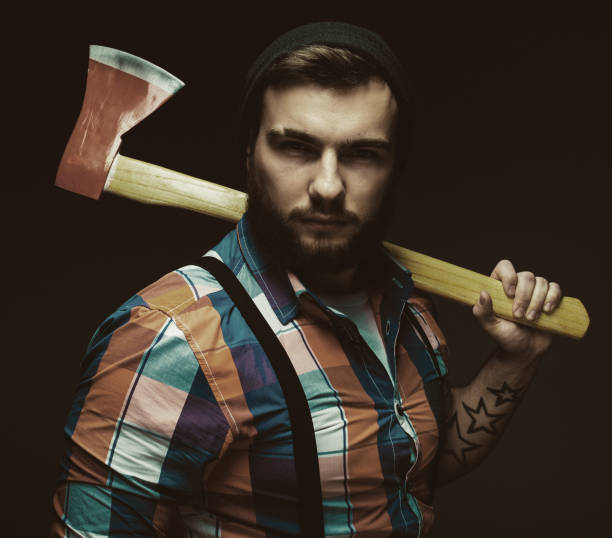 istock Brutal bearded male holds an axe on his shoulder 1352227202