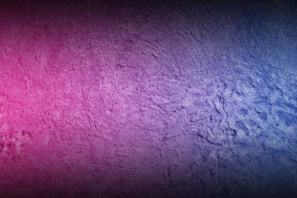 istock Black rough concrete wall background with neon lights and glowing lights. 1352227717