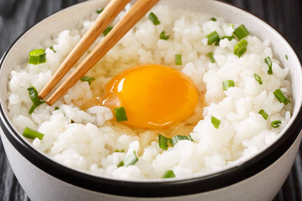 istock Tamago Kake Gohan Recipe Egg Over Rice close up in the bowl. Horizontal 1352233093