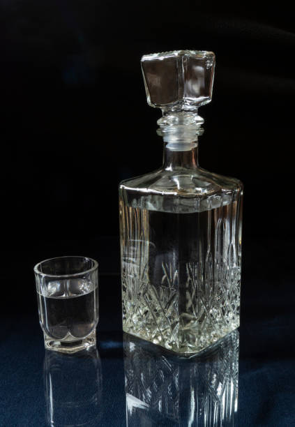 istock Vodka in a decanter and a glass on the table with a reflection 1352233127