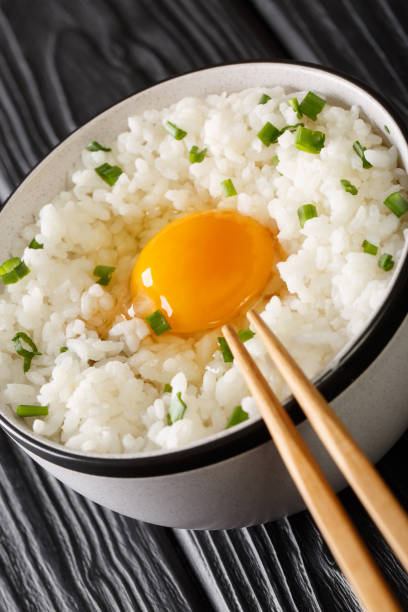 istock Tamago Kake Gohan Japanese Style Rice With Egg close up in the bowl. Vertical 1352233159