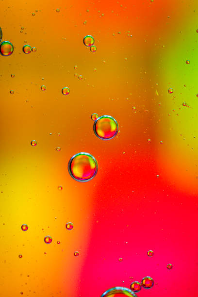 istock oil drops on a water surface abstract background with yellow and red colors 1352233184