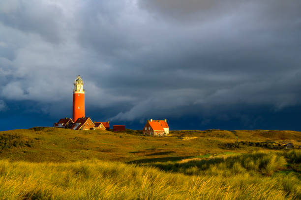 Lighthouse at the Wadden island Texel in the dunes during a stormy autumn morning. The Eierland lighthouse is located at the North point of the island.