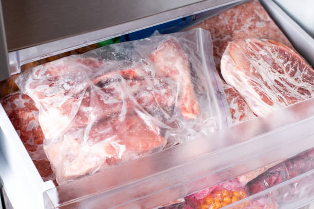 istock Frozen meat in plastic package in the freezer. 1352233253
