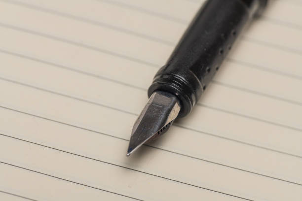 istock fountain pen on lined paper of notebook 1352234265
