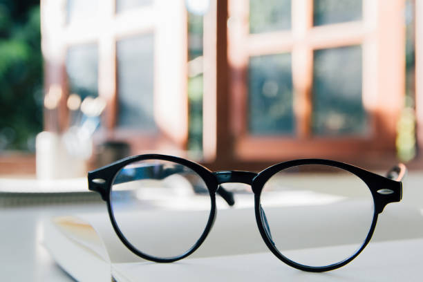istock black vintage glasses, on books, stack in a public library book, Studying examining. learning. People, learning, education 1352236028
