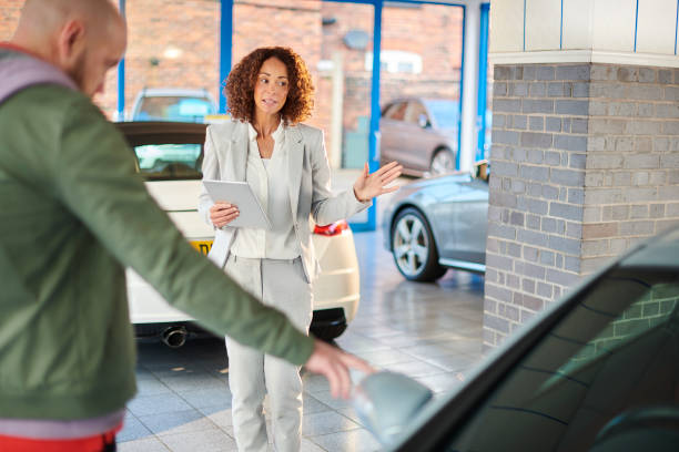 istock car sales person with customer 1352237645