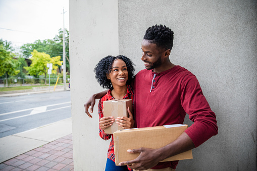 African American couple with going to the post office to send packages to clients.