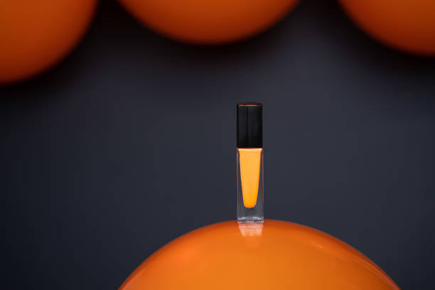 istock orange nail polish on balloon black background 1352239659
