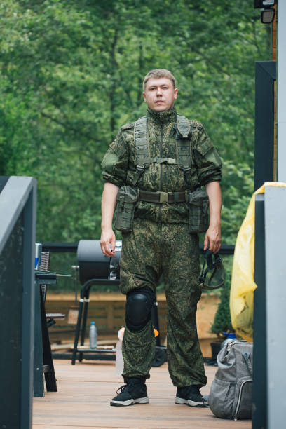 istock Military men with automatic weapons getting ready to play airsoft strikeball 1352239753