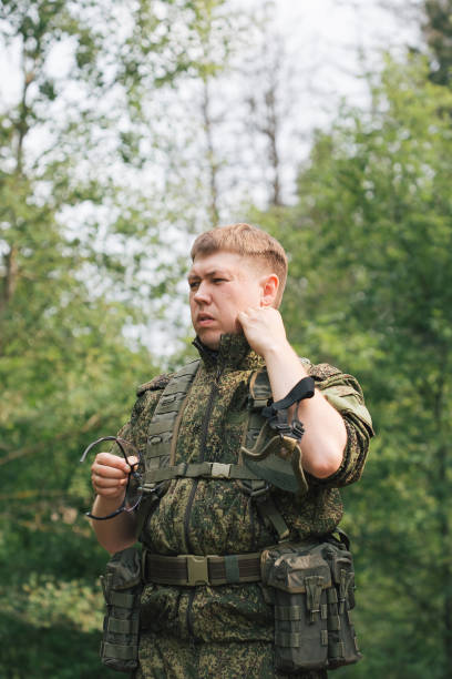 istock Military men with automatic weapons getting ready to play airsoft strikeball 1352239754