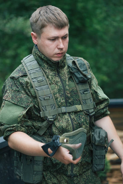 istock Military men with automatic weapons getting ready to play airsoft strikeball 1352239763